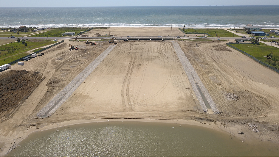 An area between two large bodies of water that has been filled in by sand.