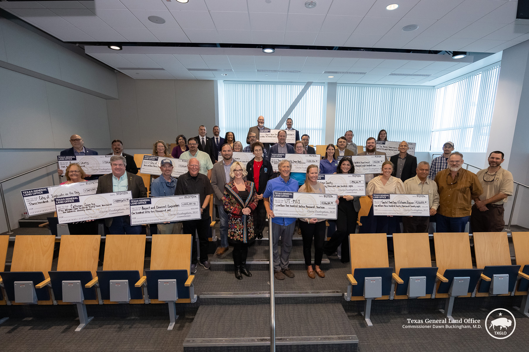 Commissioner Buckingham presented checks in Corpus Christi to the Airport and Channel Corporation, Aransas County, Calhoun County, City of Corpus Christi, City of Ingleside on the Bay, City of Port Lavaca, City of Rockport, the Coastal Bend Bays & Estuaries Program, Refugio County, Texas A&M University, Texas A&M University - Corpus Christi, Texas Parks and Wildlife Department, The Nature Conservancy Texas, and the University of Texas - Marine Science Institute while announcing a new round of GLO Coastal Re