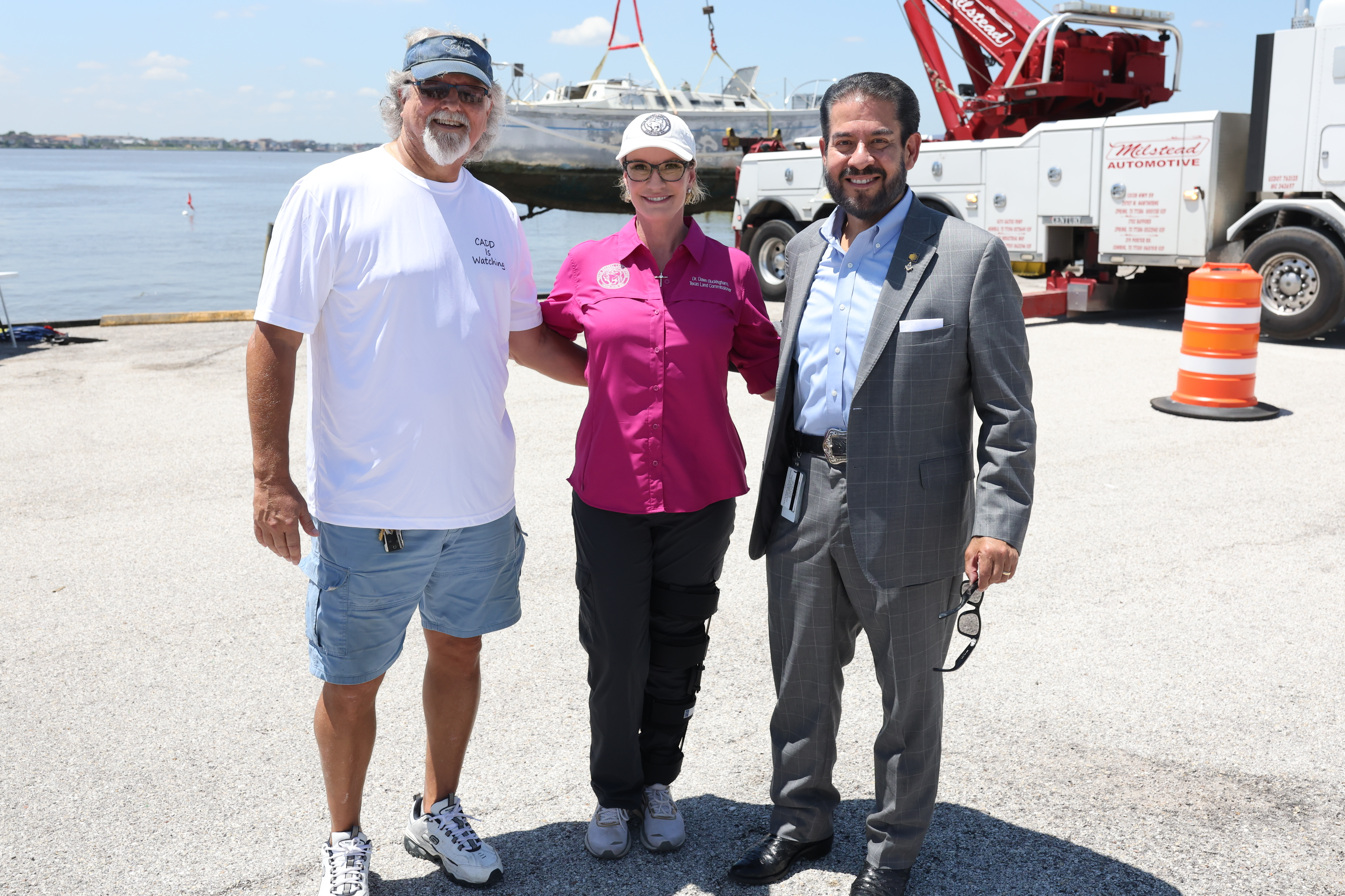 Commissioner Buckingham stands with Harris County Precinct 2 Commissioner Adrian Garcia and Russell Levigne, the CEO of Dead Boats Society, after the removal of an abandoned, derelict vessel.