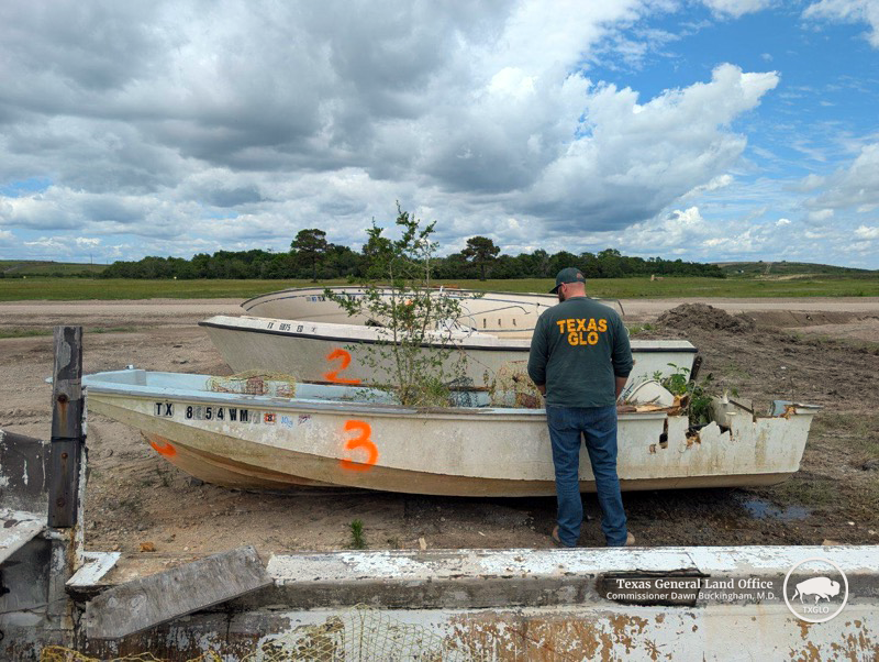 A Texas General Land Office (GLO) employee surveys vessels turned in during the Chambers County VTIP event in May 2025