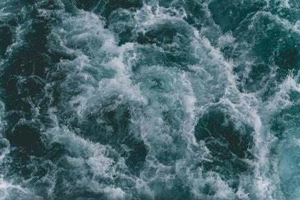A stormy ocean with waves as seen from above.