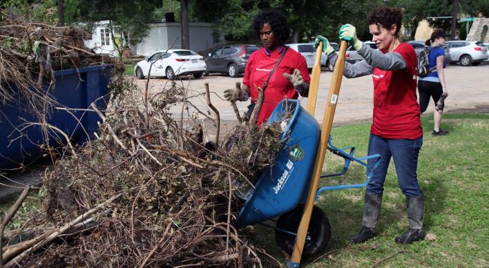 Volunteers remove debris in Pease Park as part of recovery efforts from a major Memorial Day flood.